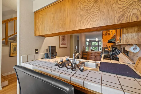 a kitchen with stainless steel appliances granite countertop a refrigerator and a stove