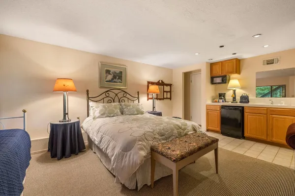 a bedroom with bed and a night stand