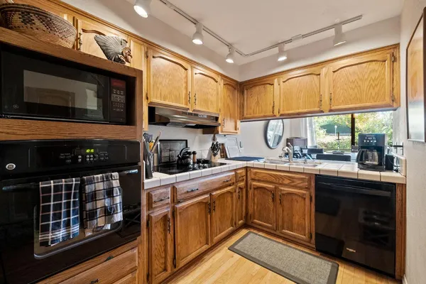 a kitchen with stainless steel appliances a stove a sink and a refrigerator