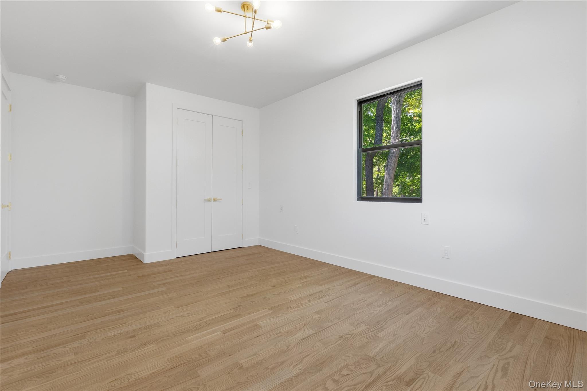 548 Lakes Road Monroe, NY 10950 - Photo 36 of 50 wooden floor in an empty room with a window