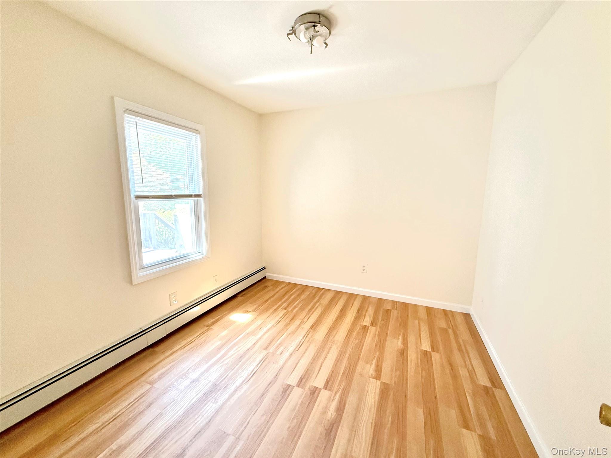 55 Red Mill Road Cortlandt Manor, NY 10567 - Photo 15 of 20 a view of an empty room with wooden floor and a window