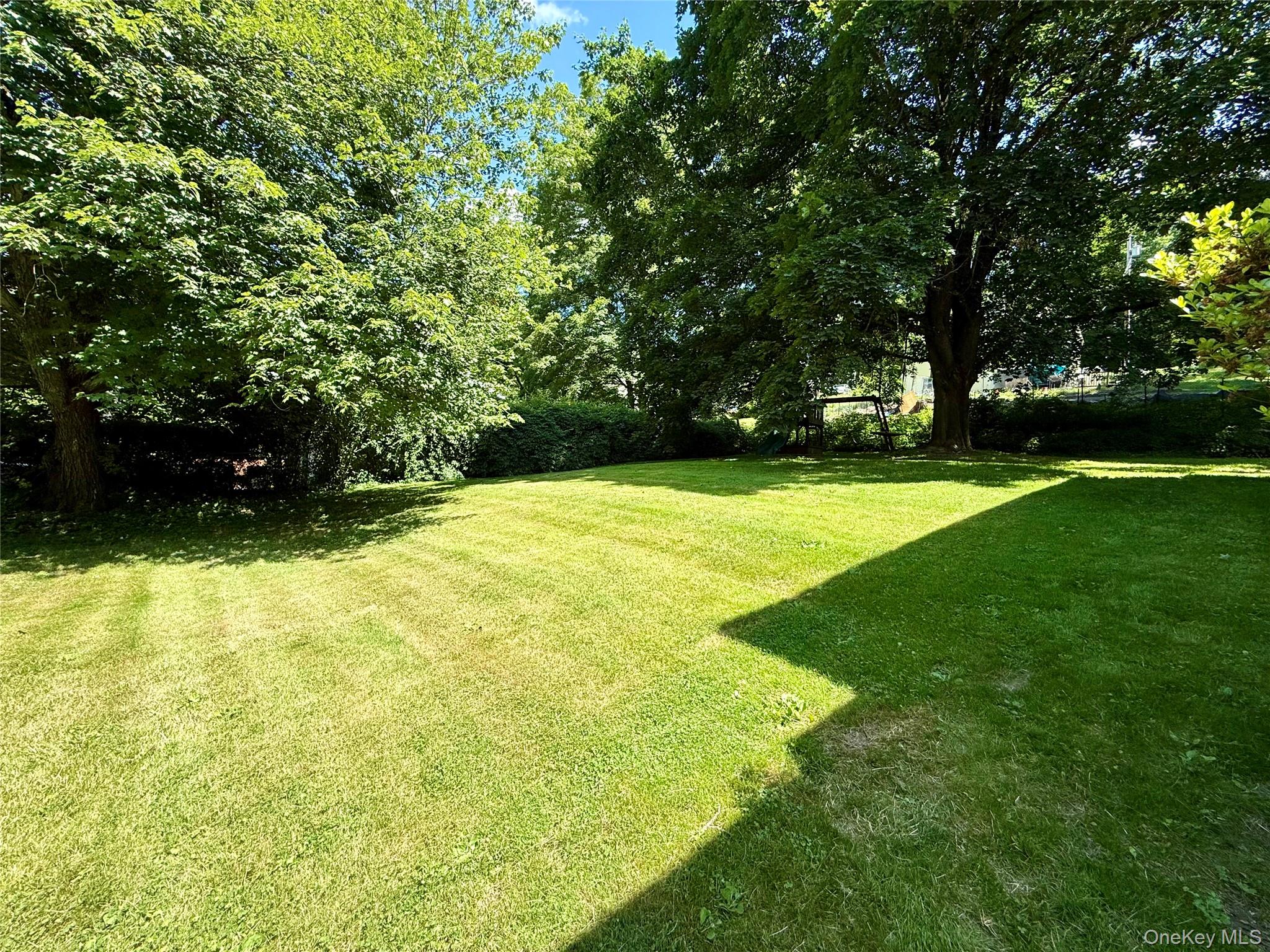 55 Red Mill Road Cortlandt Manor, NY 10567 - Photo 3 of 20 a swimming pool with wooden fence