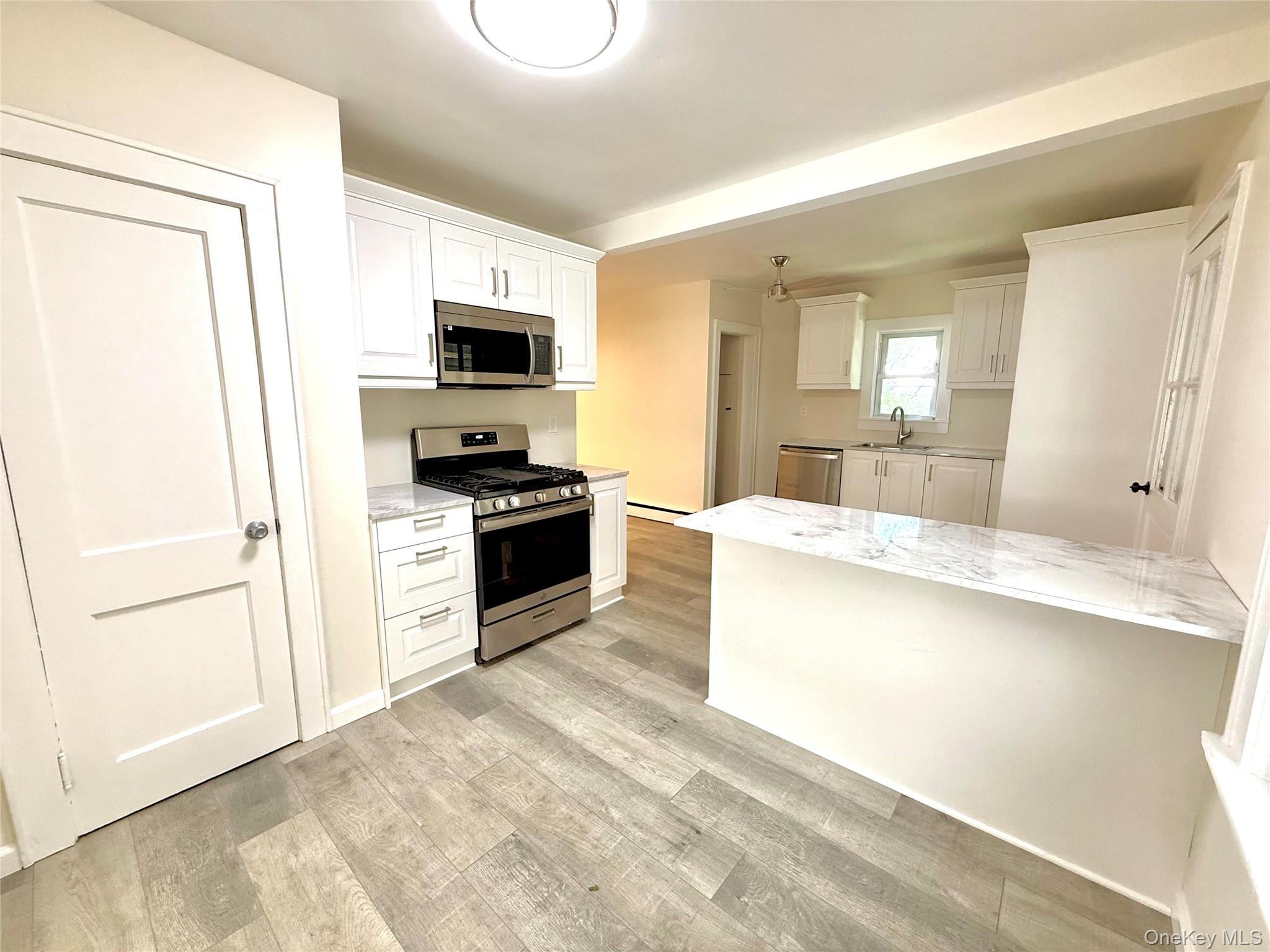 55 Red Mill Road Cortlandt Manor, NY 10567 - Photo 5 of 20 a large kitchen with granite countertop a stove and a sink