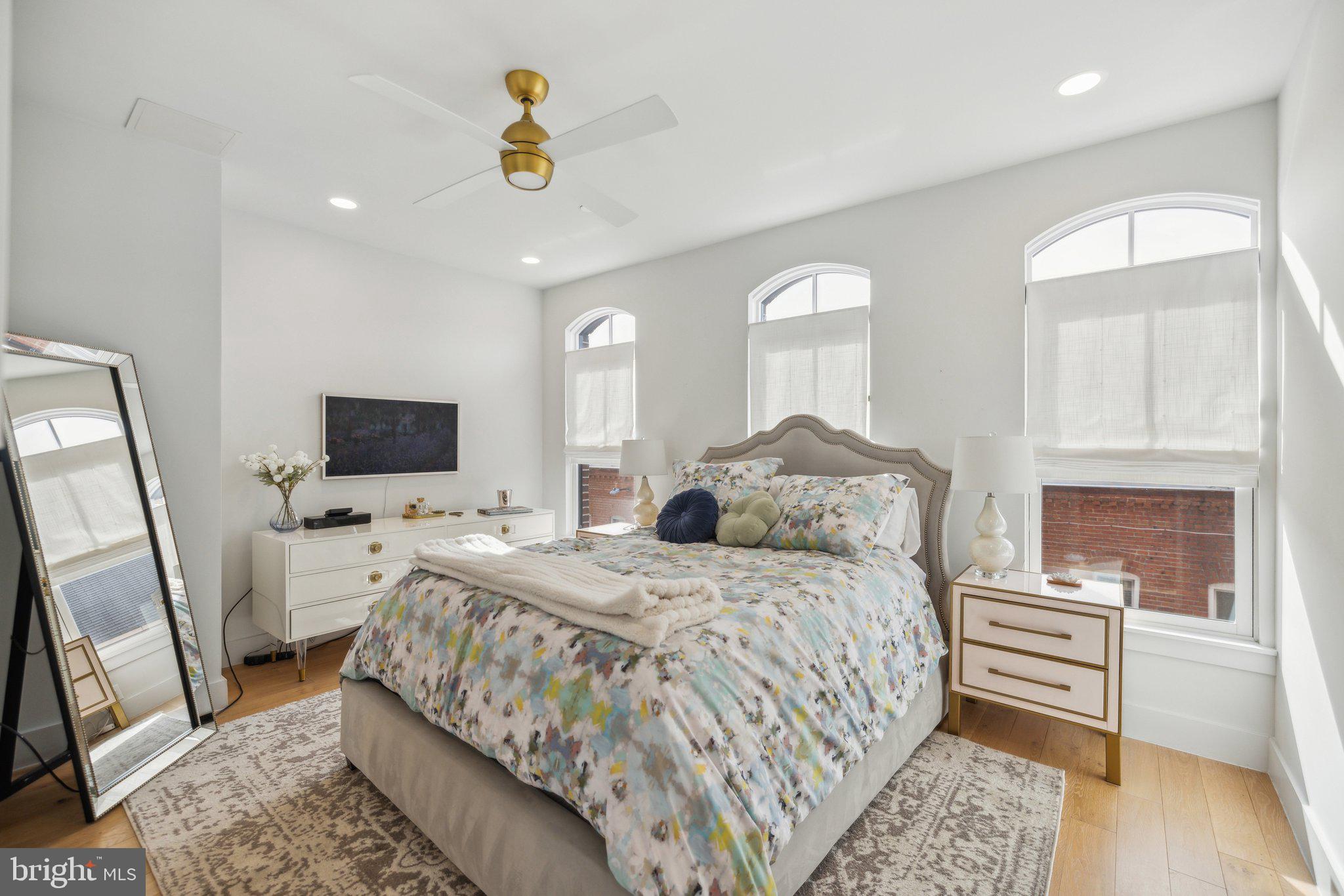 1309 E Street Southeast, Unit 36 Washington, DC 20003 - Photo 14 of 36 a bedroom with a bed a mirror on dresser and a window