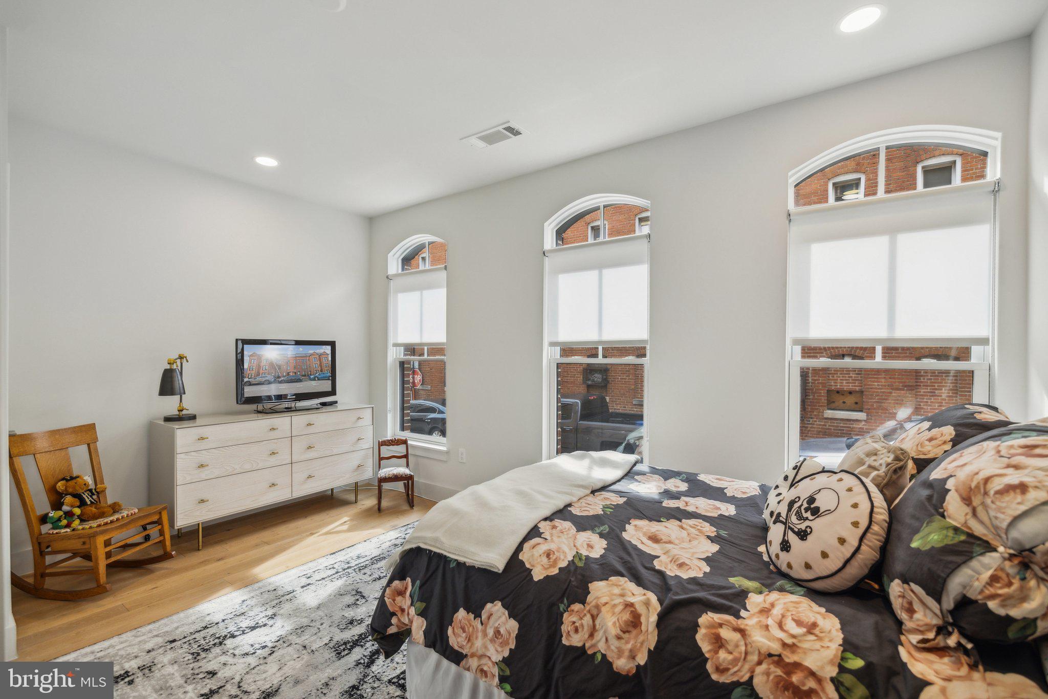 1309 E Street Southeast, Unit 36 Washington, DC 20003 - Photo 29 of 36 a bedroom with furniture and a flat tv screen