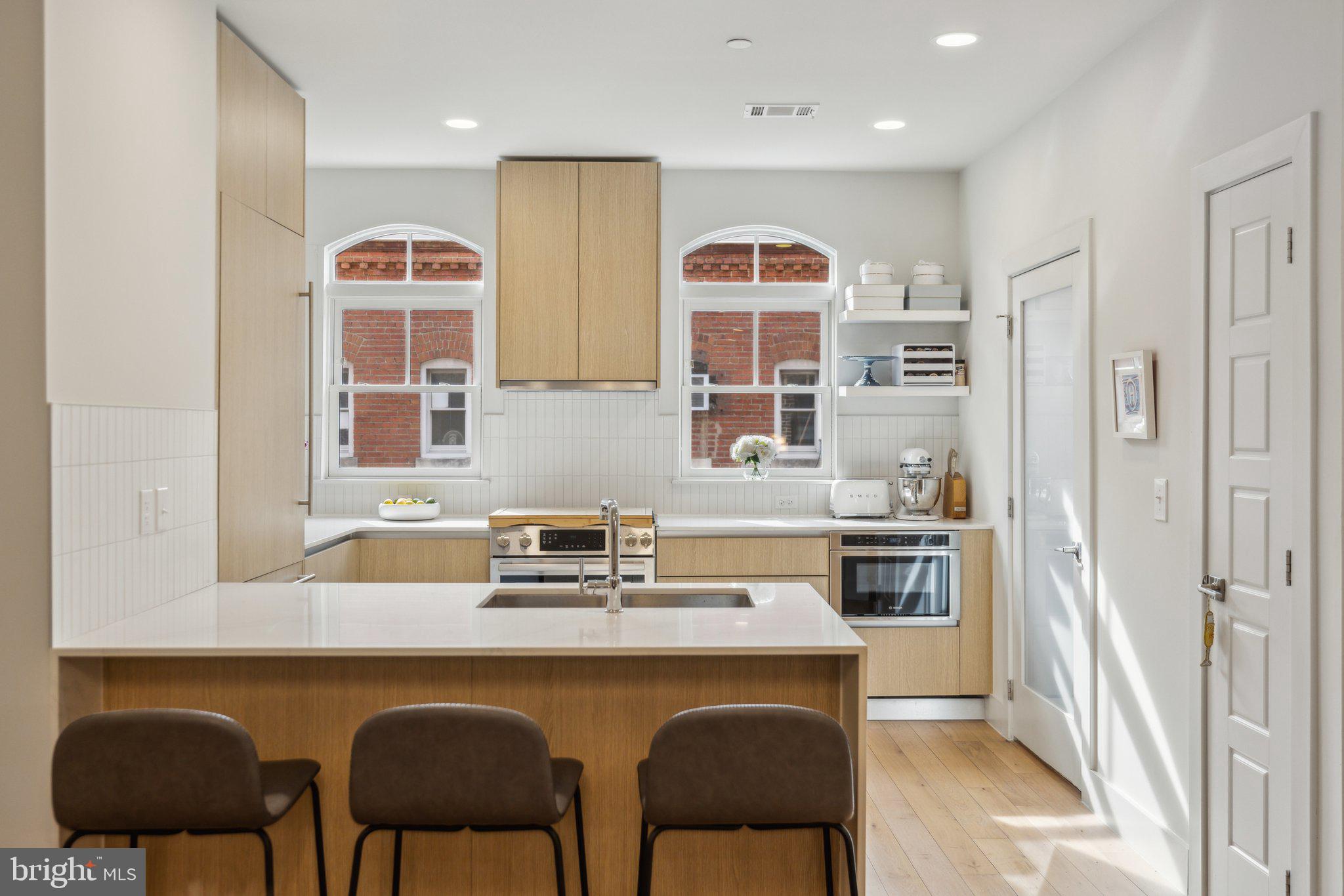 1309 E Street Southeast, Unit 36 Washington, DC 20003 - Photo 5 of 36 a kitchen with stainless steel appliances granite countertop a sink and a refrigerator