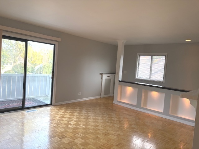 2-s717 Winchester Circle, Unit 4 Warrenville, IL 60555 - Photo 3 of 14 a view of an empty room and window