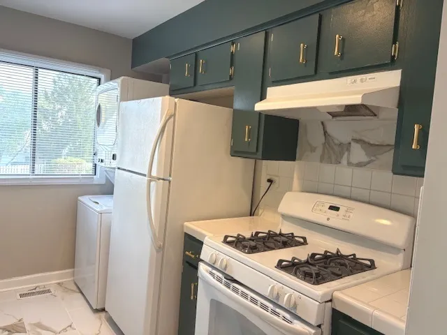 a kitchen with a refrigerator and a stove