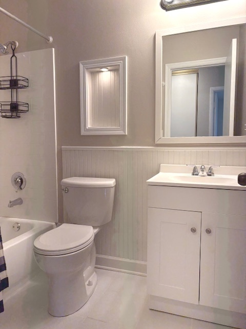 2-s717 Winchester Circle, Unit 4 Warrenville, IL 60555 - Photo 9 of 14 a bathroom with a sink a toilet and shower