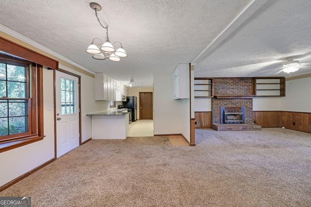 2733 Old Dawsonville Road Gainesville, GA 30506 - Photo 13 of 40 a view of an empty room with a fireplace and a window