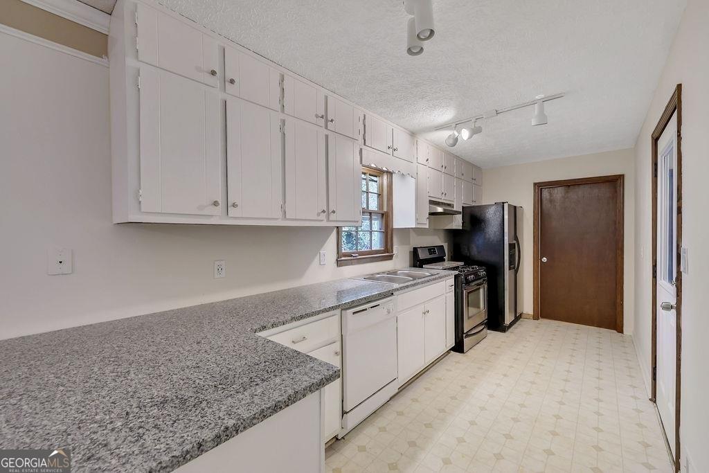 2733 Old Dawsonville Road Gainesville, GA 30506 - Photo 14 of 40 a kitchen with stainless steel appliances granite countertop a refrigerator and a sink