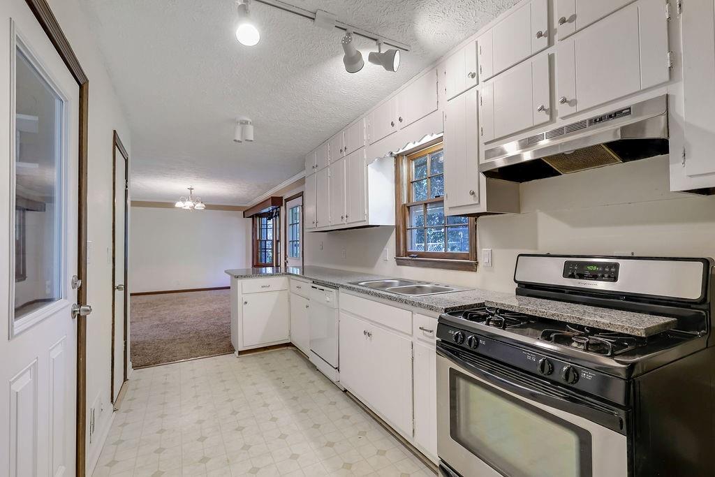 2733 Old Dawsonville Road Gainesville, GA 30506 - Photo 3 of 40 a kitchen with stainless steel appliances granite countertop a stove and a refrigerator