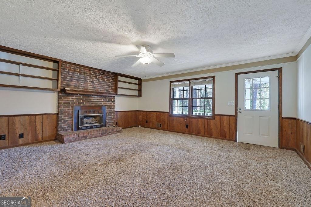 2733 Old Dawsonville Road Gainesville, GA 30506 - Photo 9 of 40 a view of an empty room with a fireplace and a window