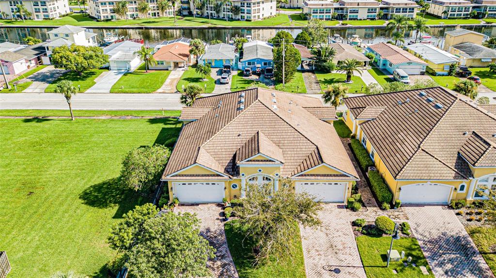 an aerial view of a house with a garden and swimming pool