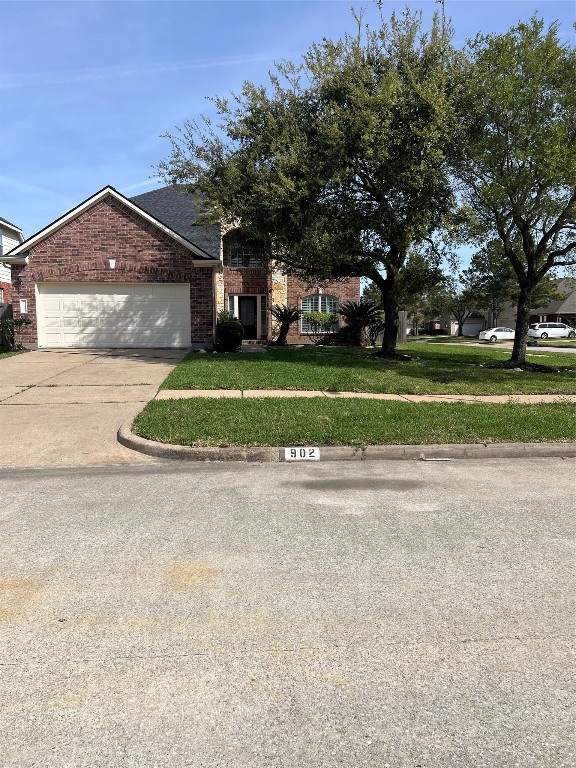 902 Brandy Street Stafford, TX 77477 - Photo 1 of 21 a front view of a house with a yard and a garage