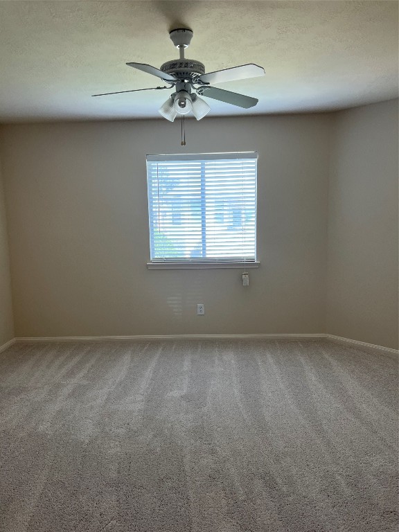 902 Brandy Street Stafford, TX 77477 - Photo 13 of 21 an empty room with a chandelier fan and windows