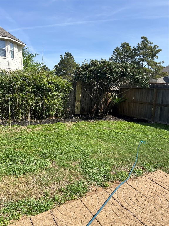 902 Brandy Street Stafford, TX 77477 - Photo 20 of 21 a garden with trees in front of it