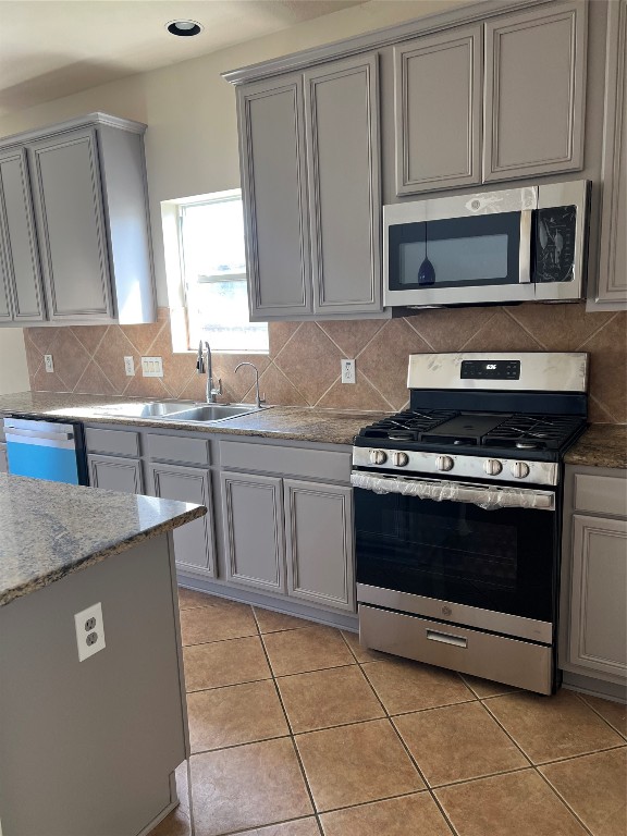 902 Brandy Street Stafford, TX 77477 - Photo 5 of 21 a kitchen with granite countertop a stove and a sink