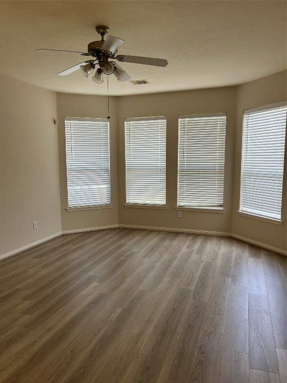 902 Brandy Street Stafford, TX 77477 - Photo 8 of 21 a view of an empty room with a window and wooden floor