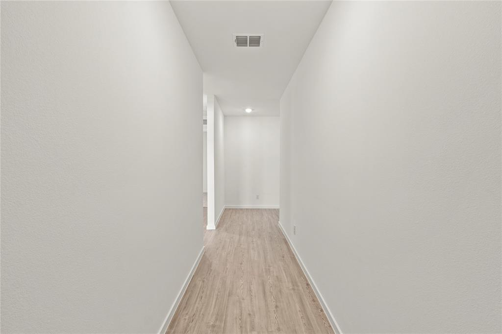 1138 Barbary Flds Street Forney, TX 75126 - Photo 19 of 25 Hallway featuring wood-finish flooring, recessed lighting, and crisp white walls