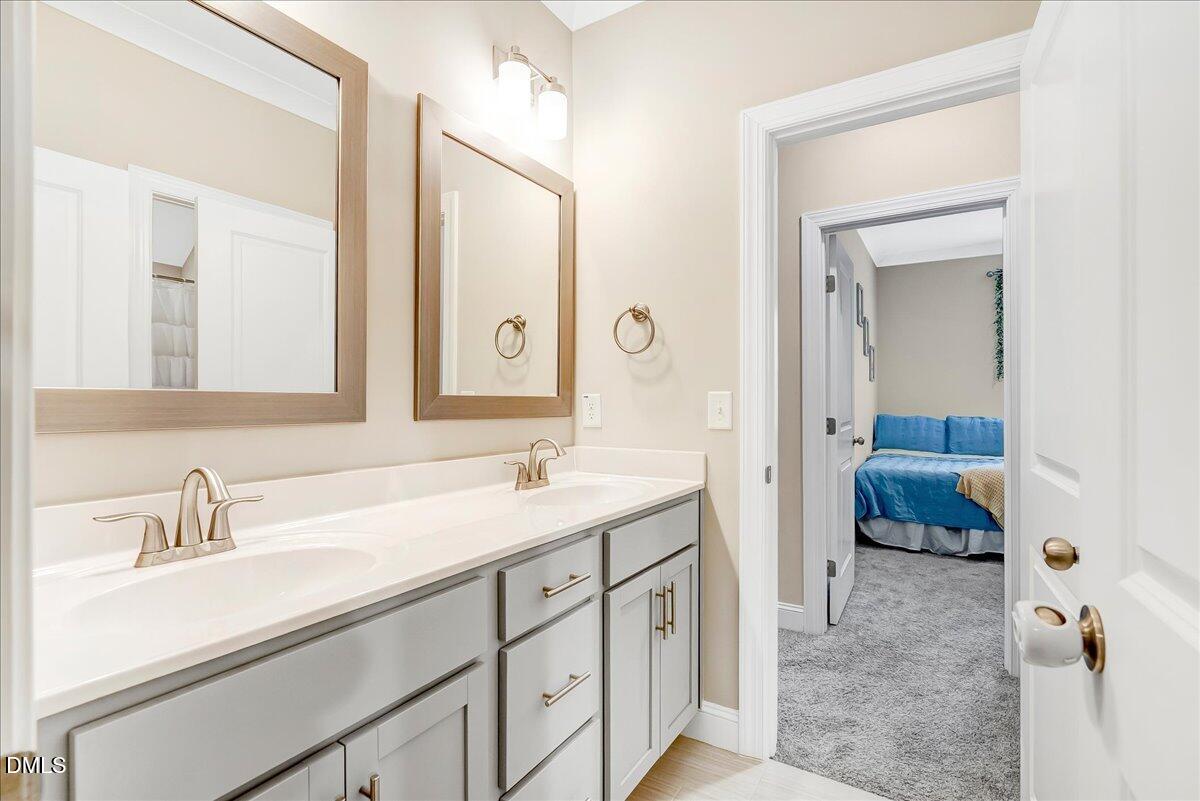 1208 Montgomery Road Franklinton, NC 27525 - Photo 25 of 61 a en suite bathroom with a sink and a mirror