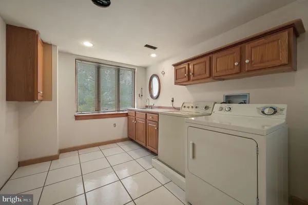 a bathroom with a bathtub sink and mirror