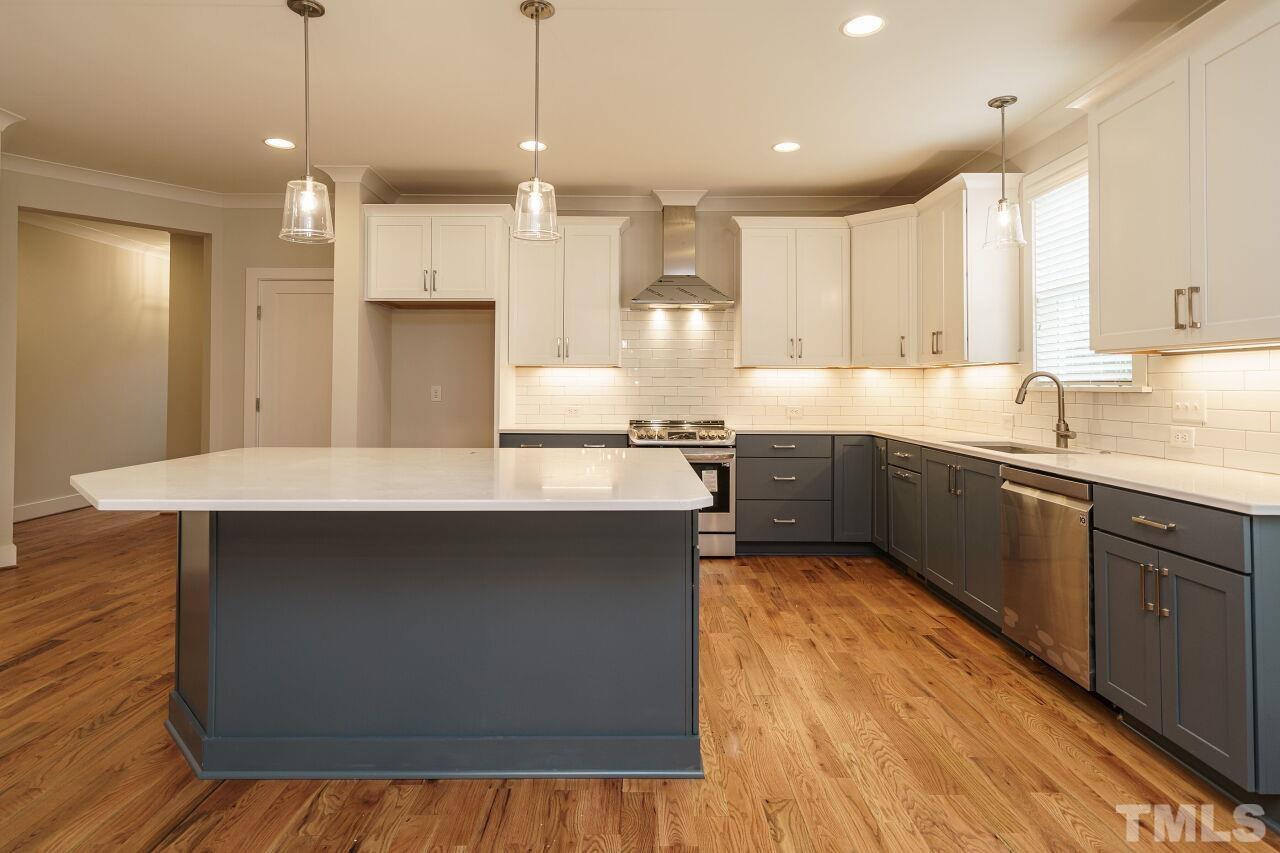 171 Adams Street Cary, NC 27513 - Photo 13 of 32 a kitchen with a sink a refrigerator and window