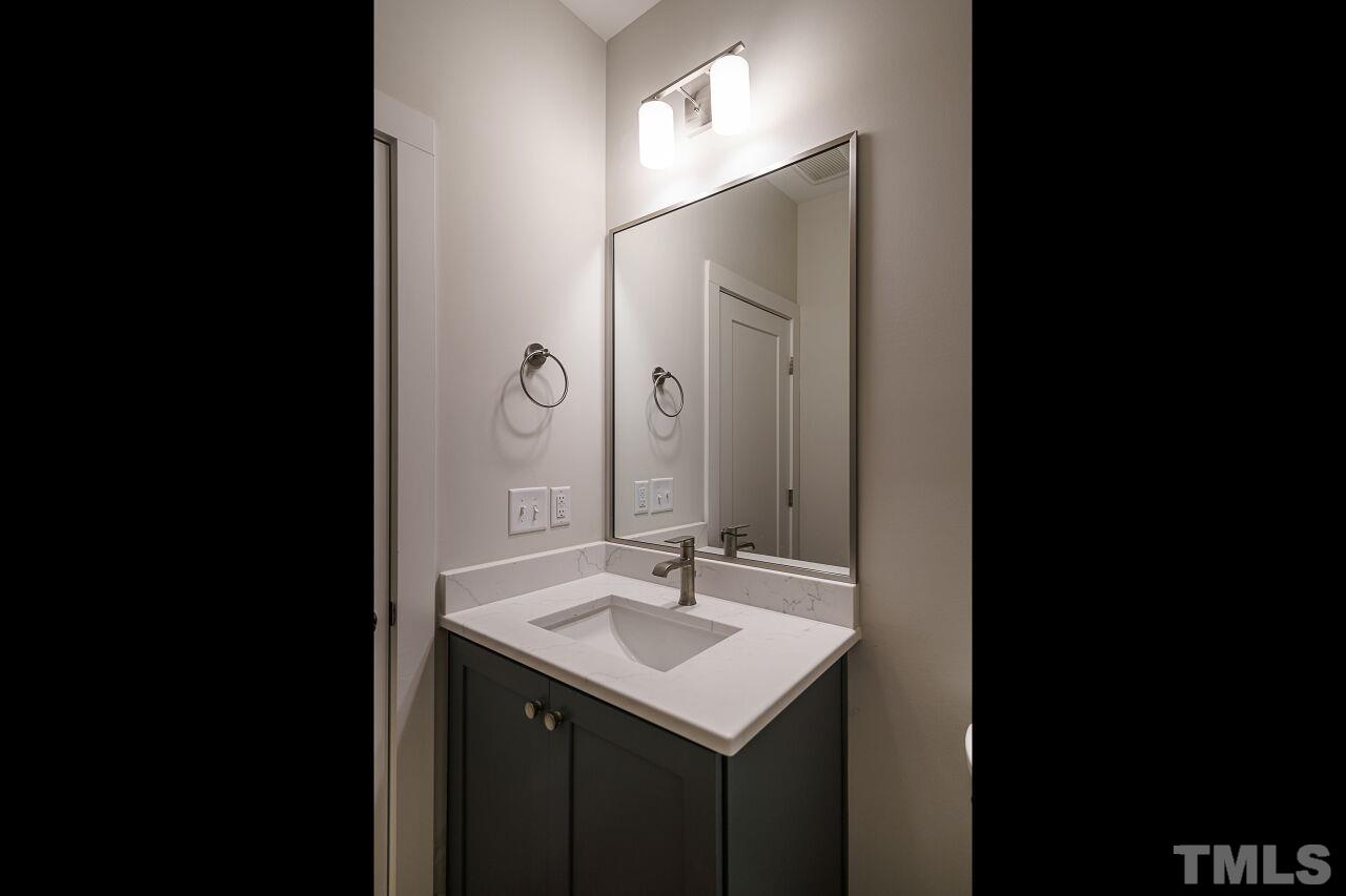 171 Adams Street Cary, NC 27513 - Photo 16 of 32 a bathroom with a sink and a mirror