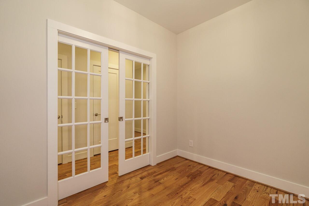 171 Adams Street Cary, NC 27513 - Photo 18 of 32 an empty room with wooden floor and windows