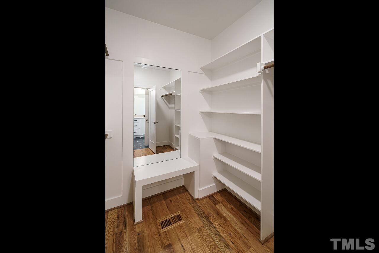 171 Adams Street Cary, NC 27513 - Photo 23 of 32 a view of a bedroom with a furniture and wooden floor