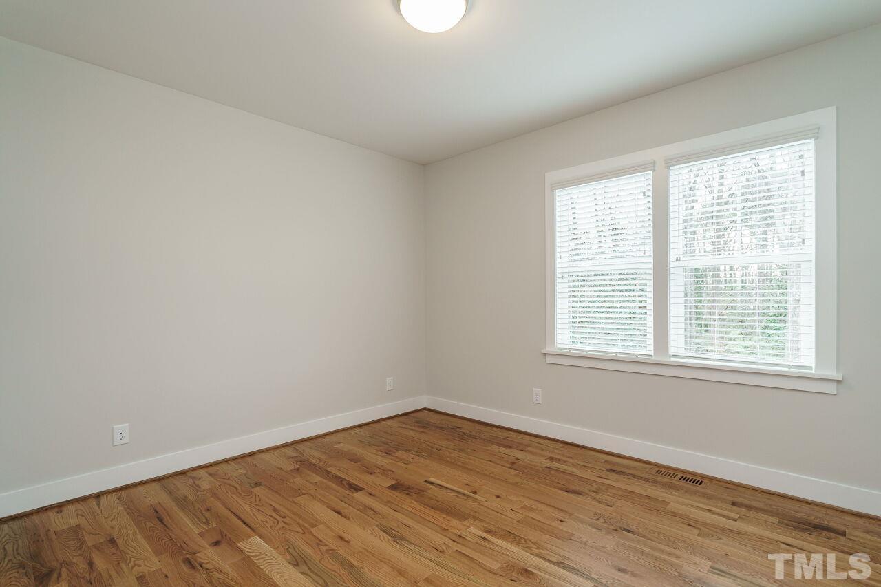 171 Adams Street Cary, NC 27513 - Photo 25 of 32 an empty room with wooden floor and windows