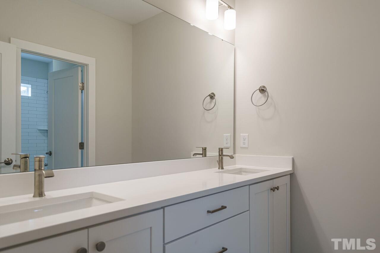 171 Adams Street Cary, NC 27513 - Photo 27 of 32 a bathroom with a sink and a mirror