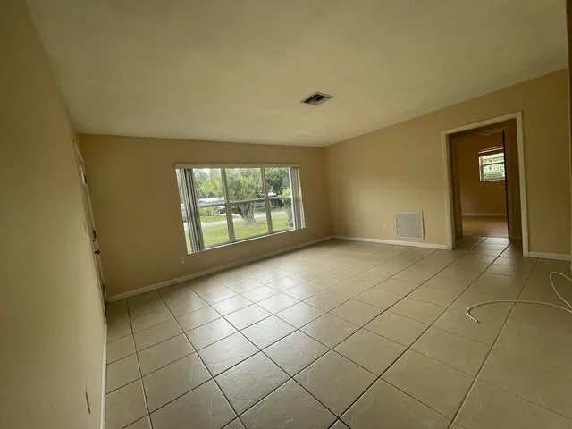 a view of an empty room with a window