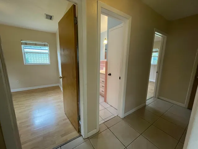 a view of a hallway with wooden floor