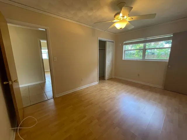 wooden floor in an empty room with a window