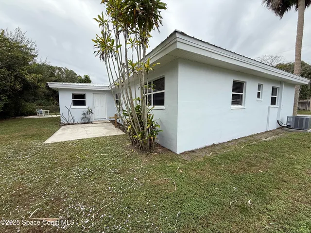 a front view of house with yard and trees