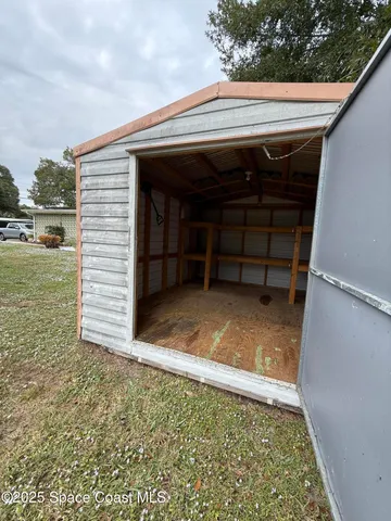 a view of backyard with wooden floor and fence