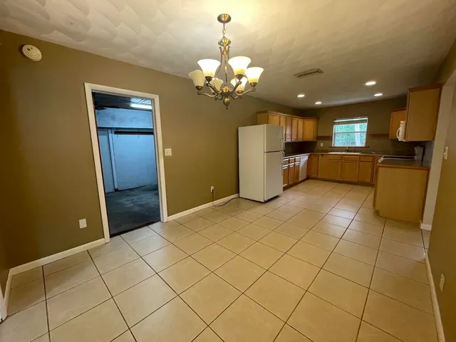 a living room with a couch and a chandelier