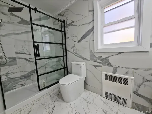 a bathroom with a toilet and a shower