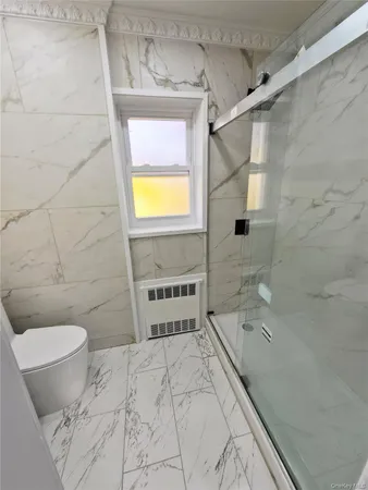 a bathroom with a bathtub and a toilet
