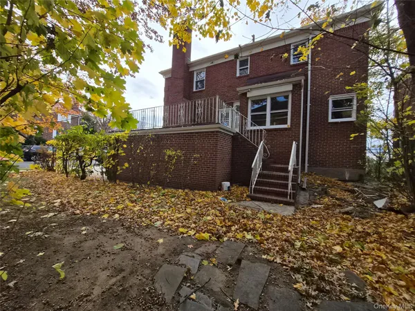 front view of a house with a tree