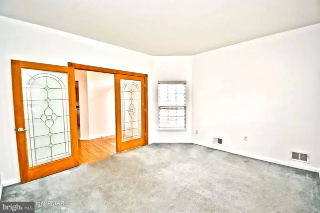 a view of an empty room with a window