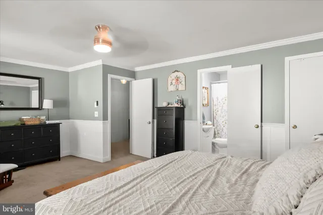 a bedroom with a bed and a dresser