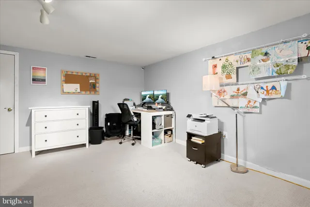 a living room with furniture and a dining table