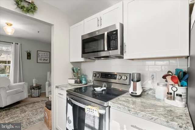 a kitchen with stainless steel appliances granite countertop a granite counter tops and a wooden floors
