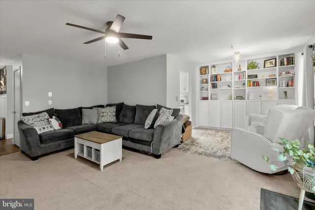 a living room with furniture and a book shelf