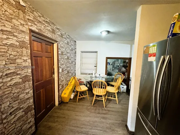 a dining room with furniture and wooden floor