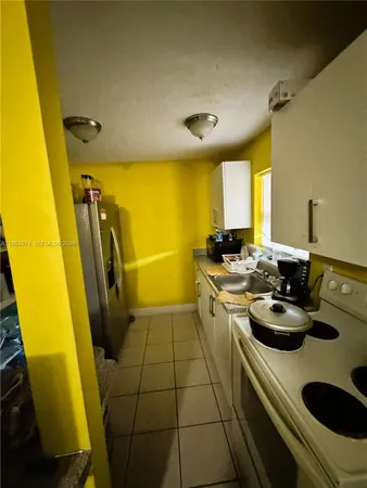 a kitchen with a sink and appliances