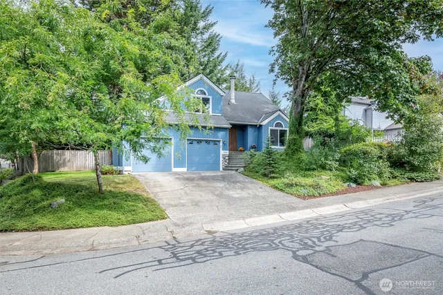 a front view of a house with a garden and plants