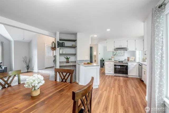 a kitchen with white cabinets and stainless steel appliances